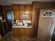 Small kitchen area featuring upper and lower wood cabinets and laminate floors at 1856 Butler Bridge Rd, Covington, GA 30016