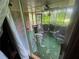 Enclosed sunroom with ceiling fan, a rocker and other chairs, and views of the yard at 1856 Butler Bridge Rd, Covington, GA 30016