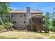 Backyard exterior of the house with a screened porch and a brick patio at 27 Rose Brooke Cir, White, GA 30184