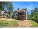 Exterior of the house with a screened porch, patio, and a lush backyard at 27 Rose Brooke Cir, White, GA 30184