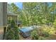 Home featuring screened porch with deck, above ground pool, and a spacious backyard at 27 Rose Brooke Cir, White, GA 30184