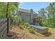 Exterior view of home featuring an above ground pool, wood fence, and mature landscaping at 27 Rose Brooke Cir, White, GA 30184