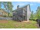 Backyard view of two story home featuring a screened porch with deck and an above ground pool at 27 Rose Brooke Cir, White, GA 30184