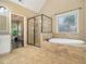 Bathroom boasts tiled floors, a tub, walk-in shower, and natural light at 27 Rose Brooke Cir, White, GA 30184
