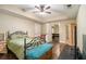 Bedroom with wooden floors, a ceiling fan, and a door leading to the game room at 27 Rose Brooke Cir, White, GA 30184