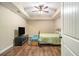 Bedroom featuring hardwood floors, ceiling fan, with a TV and neutral decor at 27 Rose Brooke Cir, White, GA 30184