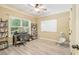 Versatile bedroom space with desk, large window, shelving, and ample natural light at 27 Rose Brooke Cir, White, GA 30184