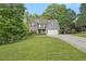 Beautiful home with stone and siding exterior, set on a well-manicured lawn with mature trees at 27 Rose Brooke Cir, White, GA 30184