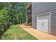 Exterior view of a home's gray siding, walkout basement, stairs to the screened porch and fenced yard at 27 Rose Brooke Cir, White, GA 30184
