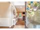 Inviting foyer leading into a living room with hardwood floors and a decorative wreath on the leaded glass door at 27 Rose Brooke Cir, White, GA 30184