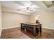 Spacious game room with hardwood floors, ceiling fan and adjacent doorway at 27 Rose Brooke Cir, White, GA 30184