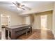 Hardwood floor in the game room offers a ceiling fan, and access to the bathroom and bedroom at 27 Rose Brooke Cir, White, GA 30184