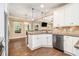 Bright kitchen with granite counters, stainless steel appliances and seamless flow to the living room at 27 Rose Brooke Cir, White, GA 30184