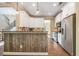 Modern kitchen with granite countertops, stainless steel appliances, and wood paneled breakfast bar at 27 Rose Brooke Cir, White, GA 30184