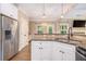 Bright kitchen featuring granite countertops, stainless steel appliances, white cabinets, and modern pendant lighting at 27 Rose Brooke Cir, White, GA 30184