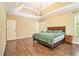 Beautiful main bedroom boasts hardwood floors, a tray ceiling, and abundant natural light at 27 Rose Brooke Cir, White, GA 30184