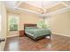 Spacious main bedroom featuring hardwood floors, a tray ceiling, and abundant natural light at 27 Rose Brooke Cir, White, GA 30184