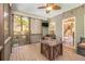 Relaxing screened porch with wooden floor, ceiling fan, comfortable seating, and natural light at 27 Rose Brooke Cir, White, GA 30184