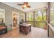 Relaxing screened porch with wooden floor, ceiling fan, comfortable seating, and natural light at 27 Rose Brooke Cir, White, GA 30184