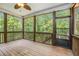 Enjoy nature views from this screened porch with a ceiling fan, and wood railings at 27 Rose Brooke Cir, White, GA 30184