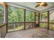Light and airy screened porch with wood floor and a view of the lush, wooded backyard at 27 Rose Brooke Cir, White, GA 30184