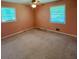 Cozy bedroom with a ceiling fan, two windows for natural light, and neutral carpeting offering a comfortable and serene space at 7125 Chappell Cir, Atlanta, GA 30360