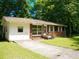 Inviting front yard featuring a well-manicured lawn, a concrete driveway, and a glimpse of the home's appealing exterior at 7125 Chappell Cir, Atlanta, GA 30360