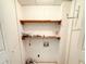 Laundry room with two shelves, hook, and all white walls at 7125 Chappell Cir, Atlanta, GA 30360