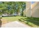 Grassy backyard perfect for outdoor activities, shaded by mature trees with a concrete patio at 1249 Scripps Sw Ct, Marietta, GA 30008