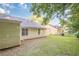 Spacious backyard featuring a well-maintained lawn with mature trees, offering privacy and shade at 1249 Scripps Sw Ct, Marietta, GA 30008