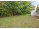 Spacious backyard featuring mature trees, green lawn and a storage shed at 1249 Scripps Sw Ct, Marietta, GA 30008
