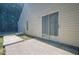 Exterior view of the home, featuring a sliding glass door and concrete patio at 1249 Scripps Sw Ct, Marietta, GA 30008