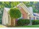 Close up of a charming single story home with brick and vinyl siding, manicured lawn, and mature trees at 1249 Scripps Sw Ct, Marietta, GA 30008