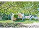 Charming single story home with brick and vinyl siding and a manicured lawn with mature trees at 1249 Scripps Sw Ct, Marietta, GA 30008