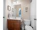 Cozy bathroom with wood vanity, neutral walls, and framed artwork at 2968 Ovalene Sw Ct, Marietta, GA 30064