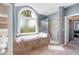 Bathroom featuring a large soaking tub, glass-enclosed shower, and tiled surround at 2968 Ovalene Sw Ct, Marietta, GA 30064