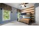 bedroom with bunk bed, neutral walls, and a leafy tree view at 2968 Ovalene Sw Ct, Marietta, GA 30064