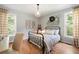 Cozy bedroom with wood floors, natural light from windows, and minimalist decor at 2968 Ovalene Sw Ct, Marietta, GA 30064