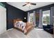 Cozy bedroom with a wood bed frame, natural light, and navy walls at 2968 Ovalene Sw Ct, Marietta, GA 30064