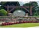 Stone and wood Paces Farm community sign with landscaped flowerbeds at 2968 Ovalene Sw Ct, Marietta, GA 30064