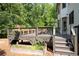 Home's deck featuring outdoor seating, mature trees, and stairs to backyard at 2968 Ovalene Sw Ct, Marietta, GA 30064