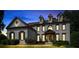 Twilight view of a beautiful home with manicured lawn and blooming flowerbeds at 2968 Ovalene Sw Ct, Marietta, GA 30064