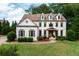 Elegant two-story home featuring white brick, dormer windows, and a manicured lawn at 2968 Ovalene Sw Ct, Marietta, GA 30064