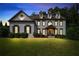 Stunning twilight view of a two-story home with a well-lit, manicured front lawn at 2968 Ovalene Sw Ct, Marietta, GA 30064