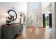 Bright foyer with hardwood floors, a round mirror, and natural light from large windows at 2968 Ovalene Sw Ct, Marietta, GA 30064