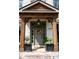 Charming front door with a floral wreath, dark trim and wooden porch columns at 2968 Ovalene Sw Ct, Marietta, GA 30064