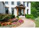 Close-up of a charming front porch with colorful flowerbeds and a winding walkway at 2968 Ovalene Sw Ct, Marietta, GA 30064