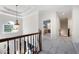 Upstairs hallway featuring light gray carpet, a pendant light and views of the foyer at 2968 Ovalene Sw Ct, Marietta, GA 30064
