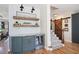 Hallway with accent wall, beverage station, and a sliding barn door leading to stairs at 2968 Ovalene Sw Ct, Marietta, GA 30064
