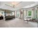 Spacious main bedroom with decorative wallpaper, carpeting, sitting area, and multiple windows at 2968 Ovalene Sw Ct, Marietta, GA 30064